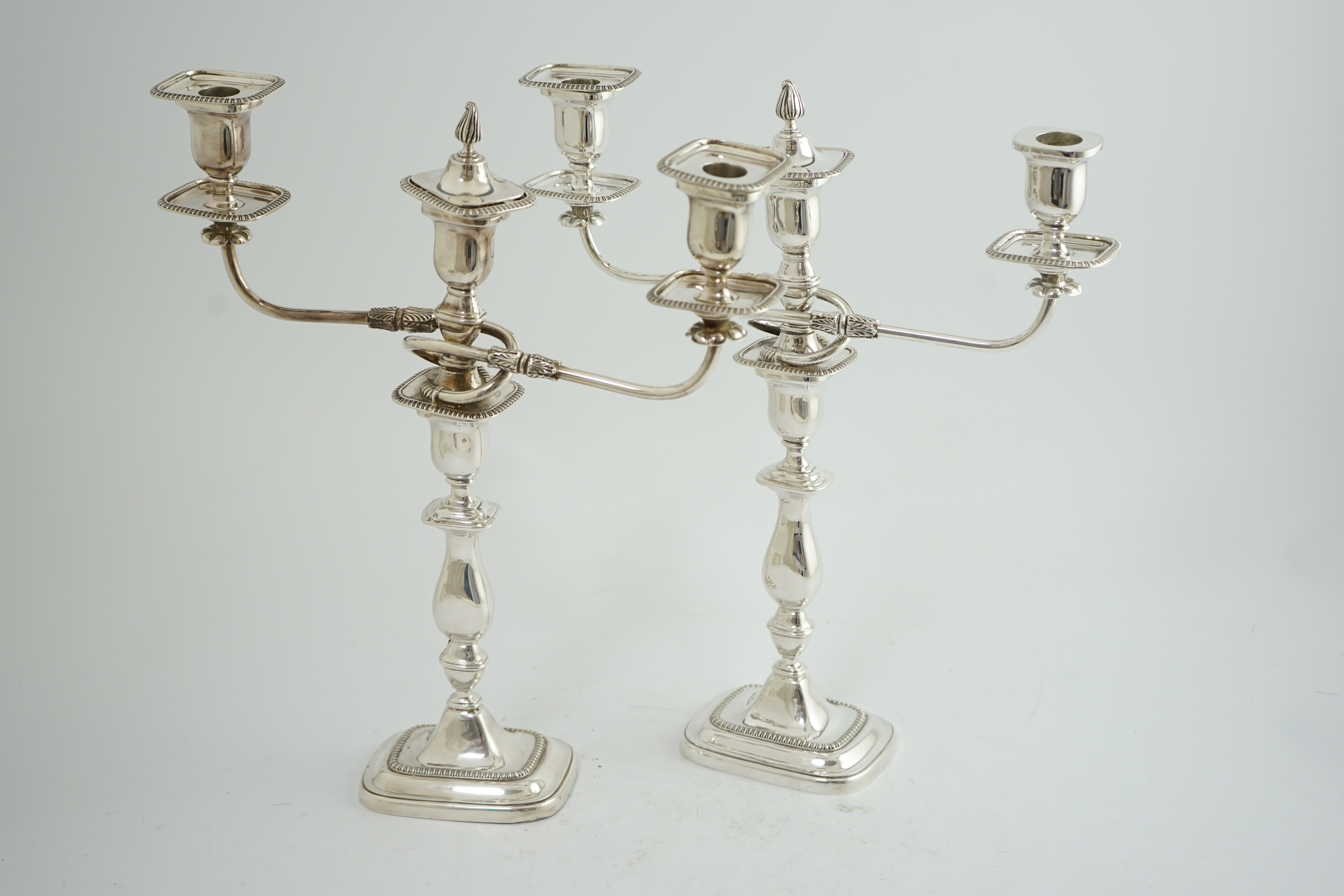 A pair of Elizabeth II silver two branch two light candelabra, by James Dixon & Sons